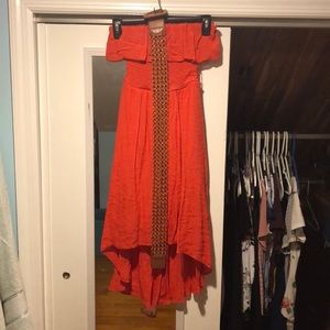 A red-orange dress, off the shoulder with belt